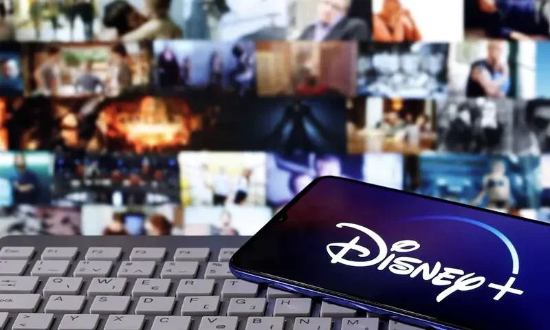 A smartphone with displayed "Disney" logo is seen on the keyboard in this illustration taken March 24, 2020. REUTERS/Dado Ruvic