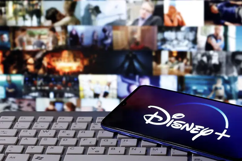 A smartphone with displayed "Disney" logo is seen on the keyboard in this illustration taken March 24, 2020. REUTERS/Dado Ruvic