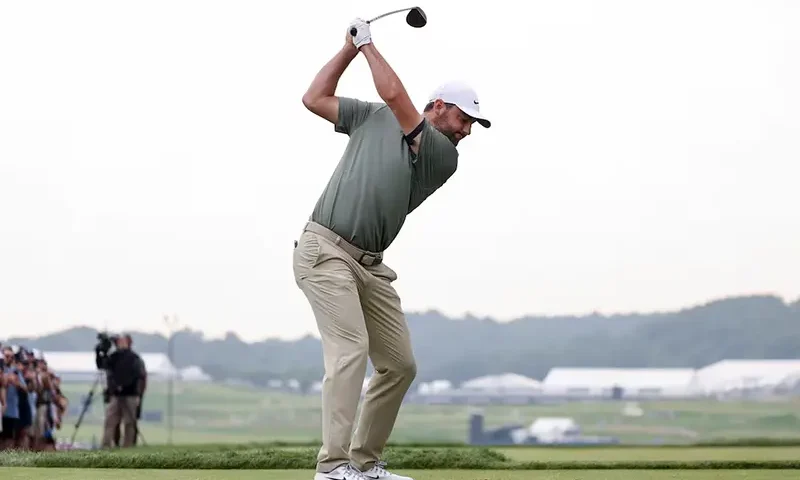 Scottie Scheffler plays his shot from the tenth tee during the second round of the U.S. Open golf tournament. Mandatory Credit: Bill Streicher-Imagn Images