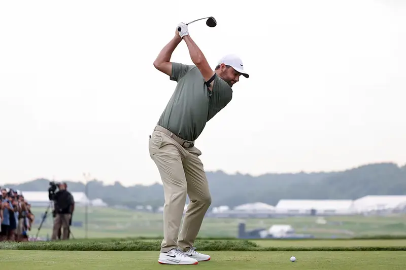 Scottie Scheffler plays his shot from the tenth tee during the second round of the U.S. Open golf tournament. Mandatory Credit: Bill Streicher-Imagn Images