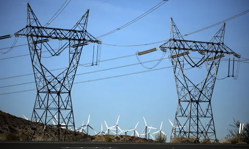 Windmills are seen behind electricity pylons in Palm Springs, California, U.S., November 25, 2017. REUTERS/Lucy Nicholson/File Photo