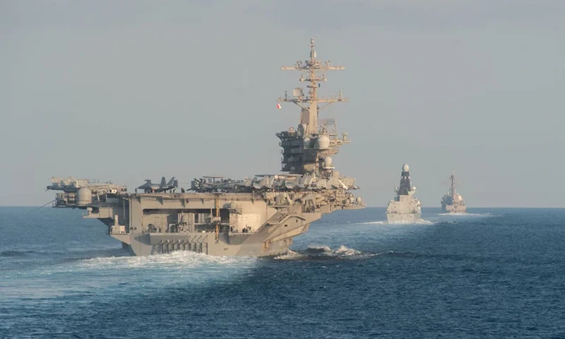 STRAIT OF HORMUZ - NOVEMBER 19: In this handout photo provided by the US Navy, The aircraft carrier USS Abraham Lincoln (CVN 72), left, the Royal Navy air defense destroyer HMS Defender (D 36) and the guided-missile destroyer USS Farragut (DDG 99) transit the Strait of Hormuz on November 19, 2019. The Abraham Lincoln Carrier Strike Group is deployed to the U.S. 5th Fleet area of operations in support of naval operations to ensure maritime stability and security in the Central Region, connecting the Mediterranean and the Pacific through the western Indian Ocean and three strategic choke points. With Abraham Lincoln as the flagship, deployed strike group assets include staffs, ships and aircraft of Carrier Strike Group (CSG) 12, Destroyer Squadron (DESRON) 2, the guided-missile cruiser USS Leyte Gulf (CG 55) and Carrier Air Wing (CVW) 7. (Photo by Zachary Pearson- U.S. Navy via Getty Images)