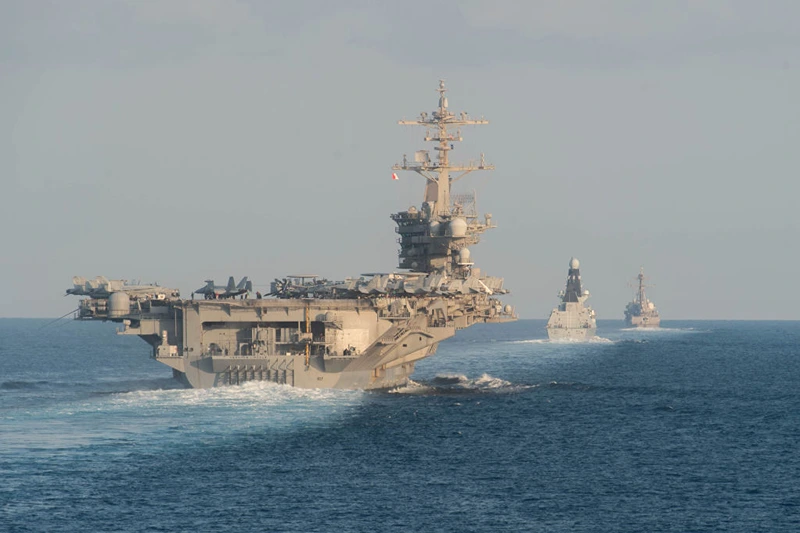 STRAIT OF HORMUZ - NOVEMBER 19: In this handout photo provided by the US Navy, The aircraft carrier USS Abraham Lincoln (CVN 72), left, the Royal Navy air defense destroyer HMS Defender (D 36) and the guided-missile destroyer USS Farragut (DDG 99) transit the Strait of Hormuz on November 19, 2019. The Abraham Lincoln Carrier Strike Group is deployed to the U.S. 5th Fleet area of operations in support of naval operations to ensure maritime stability and security in the Central Region, connecting the Mediterranean and the Pacific through the western Indian Ocean and three strategic choke points. With Abraham Lincoln as the flagship, deployed strike group assets include staffs, ships and aircraft of Carrier Strike Group (CSG) 12, Destroyer Squadron (DESRON) 2, the guided-missile cruiser USS Leyte Gulf (CG 55) and Carrier Air Wing (CVW) 7. (Photo by Zachary Pearson- U.S. Navy via Getty Images)