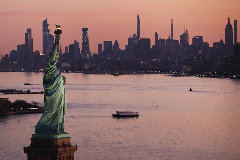 Dawn breaks over The Statue of Liberty as Manhattan and the nation struggles to contain the number of coronavirus cases on March 18, 2020 in New York City. Across the city businesses, schools and places of work have been shutting down leading to empty streets and quiet neighborhoods. New York City mayor Bill de Blasio has threatened to call for a 'shelter-in-place' order as Manhattan continues to see a rise in cases of the virus. World wide, 200,000 people have now contracted COVID-19. (Photo by Spencer Platt/Getty Images)