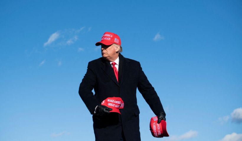 TOPSHOT - US President Donald Trump throws hats to supporters during a Make America Great Again rally at Wilkes-Barre Scranton International Airport November 2, 2020, in Avoca, Pennsylvania. The US presidential campaign enters its final day Monday with a last-minute scramble for votes by Donald Trump and Joe Biden, drawing to a close an extraordinary race that has put a pandemic-stricken country on edge. (Photo by Brendan Smialowski / AFP) (Photo by BRENDAN SMIALOWSKI/AFP via Getty Images)