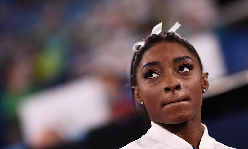 TOPSHOT - USA's Simone Biles reacts during the artistic gymnastics women's team final during the Tokyo 2020 Olympic Games at the Ariake Gymnastics Centre in Tokyo on July 27, 2021. (Photo by Loic VENANCE / AFP) (Photo by LOIC VENANCE/AFP via Getty Images)