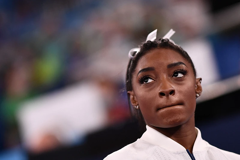 TOPSHOT - USA's Simone Biles reacts during the artistic gymnastics women's team final during the Tokyo 2020 Olympic Games at the Ariake Gymnastics Centre in Tokyo on July 27, 2021. (Photo by Loic VENANCE / AFP) (Photo by LOIC VENANCE/AFP via Getty Images)