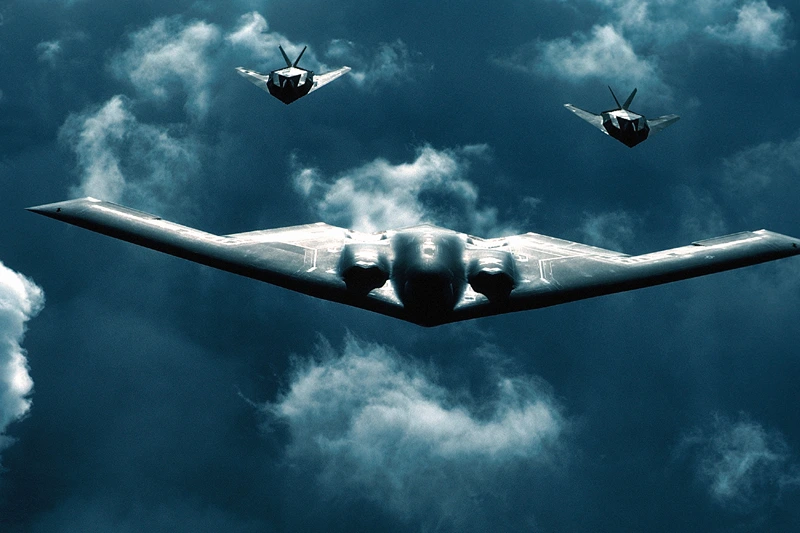 373879 01: A B-2 Spirit bomber, center, flies with two F-117A Nighthawks, July 19, 2000 above dramatic clouds. The B-2 Spirit is a multi-role bomber capable of delivering both conventional and nuclear munitions. (Photo courtesy of U.S. Air Force)