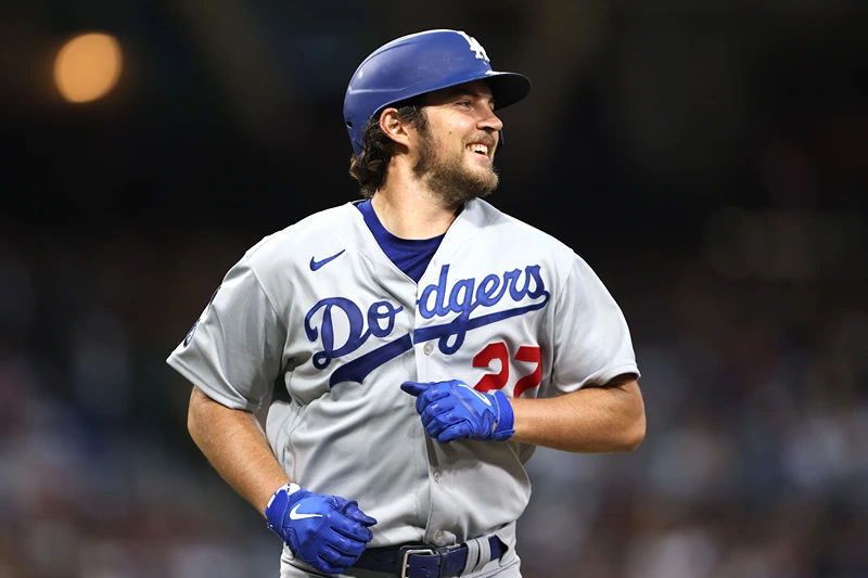 Trevor Bauer #27 of the Los Angeles Dodgers laughs after grounding out in the third inning of a game against the San Diego Padres at PETCO Park on June 23, 2021 in San Diego, California. (Photo by Sean M. Haffey/Getty Images)