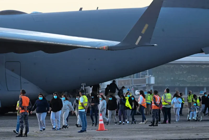 Guatemalan migrants deported from the United States on a U.S. military plane walk down the runway at the Guatemalan Air Force Base in Guatemala City on January 30, 2025. (Photo by JOHAN ORDONEZ / AFP) (Photo by JOHAN ORDONEZ/AFP via Getty Images)