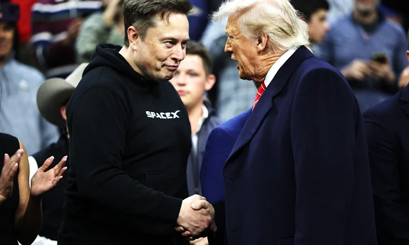 PHILADELPHIA, PENNSYLVANIA - MARCH 22: President Donald Trump and White House Senior Advisor, Tesla and SpaceX CEO Elon Musk shake hands while attending the NCAA Division I Wrestling Championship on March 22, 2025 in Philadelphia, Pennsylvania. Trump last attended the NCAA wrestling championship in 2023 and has attended high-level sporting events since becoming president in January. (Photo by Kayla Bartkowski/Getty Images)