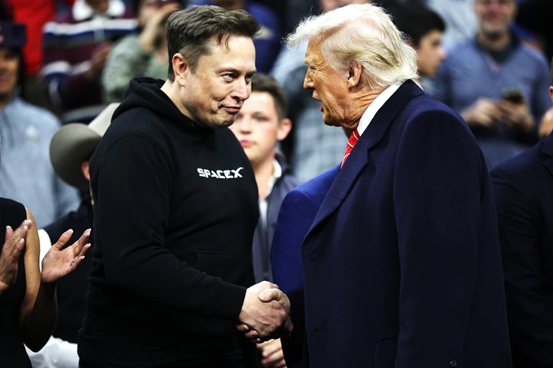 PHILADELPHIA, PENNSYLVANIA - MARCH 22: President Donald Trump and White House Senior Advisor, Tesla and SpaceX CEO Elon Musk shake hands while attending the NCAA Division I Wrestling Championship on March 22, 2025 in Philadelphia, Pennsylvania. Trump last attended the NCAA wrestling championship in 2023 and has attended high-level sporting events since becoming president in January. (Photo by Kayla Bartkowski/Getty Images)