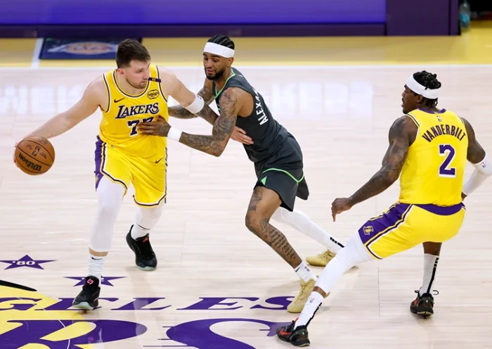 Luka Doncic #77 of the Los Angeles Lakers attempts to use a screen set by Jarred Vanderbilt #2 on Nickeil Alexander-Walker #9 of the Minnesota Timberwolves during a 103-96 Timberwolves win in Game Five of the Western Conference First Round NBA Playoffs at Crypto.com Arena on April 30, 2025 in Los Angeles, California. NOTE TO USER: User expressly acknowledges and agrees that, by downloading and or using this photograph, User is consenting to the terms and conditions of the Getty Images License Agreement. (Photo by Harry How/Getty Images)