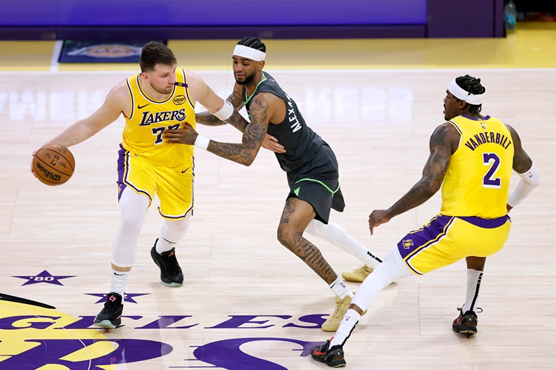 Luka Doncic #77 of the Los Angeles Lakers attempts to use a screen set by Jarred Vanderbilt #2 on Nickeil Alexander-Walker #9 of the Minnesota Timberwolves during a 103-96 Timberwolves win in Game Five of the Western Conference First Round NBA Playoffs at Crypto.com Arena on April 30, 2025 in Los Angeles, California. NOTE TO USER: User expressly acknowledges and agrees that, by downloading and or using this photograph, User is consenting to the terms and conditions of the Getty Images License Agreement. (Photo by Harry How/Getty Images)