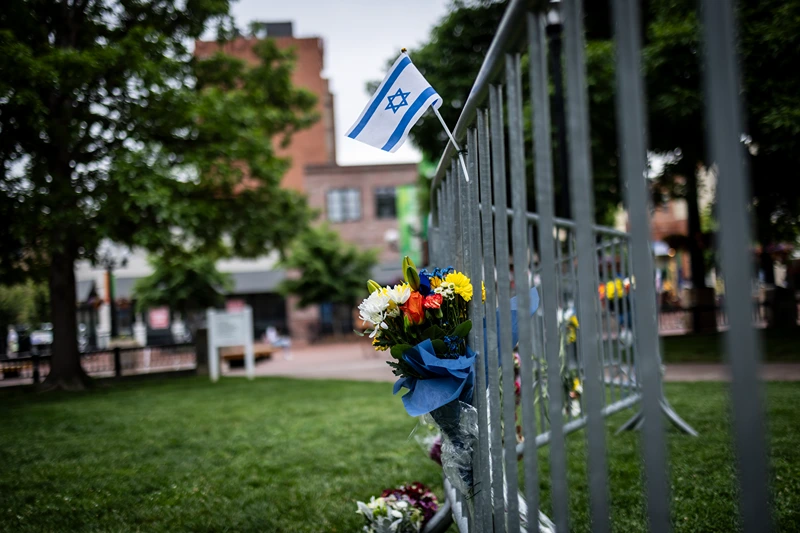 Flowers and a flag at the site of the attack outside the Boulder County Courthouse on June 2, 2025 in Boulder, Colorado. A suspect is in custody after reportedly throwing incendiary devices at a group participating in an organized walk to show solidarity with hostages held by Hamas in Gaza. The suspect, an Egyptian citizen who had overstayed his visa, has been charged with a hate crime by the F.B.I. (Photo by Chet Strange/Getty Images)