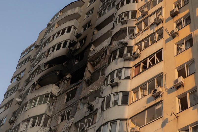 A man looks out from a burned apartment in a residential building damaged during a Russian air strike in Kyiv on June 6, 2025, amid the Russian invasion of Ukraine. Russia carried out a barrage of drone strikes across Ukraine overnight, killing at least four people and wounding 20 in the capital Kyiv, Ukrainian officials said on June 6. (Photo by Roman PILIPEY / AFP) (Photo by ROMAN PILIPEY/AFP via Getty Images)