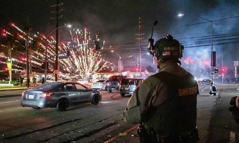 LOS ANGELES, CALIFORNIA - JUNE 7: A firework sent by protesters explodes near by the Los Angeles Sheriff Department officers during immigration protest on June 7, 2025 in Paramount, California. Clashes between the U.S. Border Patrol and protestors began after a Home Depot was raided by Immigration and Customs Enforcement (ICE). Around 30 agents wearing tactical gear were stationed near a Home Depot in Paramount and faced off against protesters, south of downtown Los Angeles.(Photo by Apu Gomes/Getty Images)