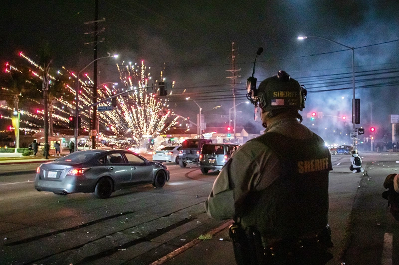 LOS ANGELES, CALIFORNIA - JUNE 7: A firework sent by protesters explodes near by the Los Angeles Sheriff Department officers during immigration protest on June 7, 2025 in Paramount, California. Clashes between the U.S. Border Patrol and protestors began after a Home Depot was raided by Immigration and Customs Enforcement (ICE). Around 30 agents wearing tactical gear were stationed near a Home Depot in Paramount and faced off against protesters, south of downtown Los Angeles.(Photo by Apu Gomes/Getty Images)