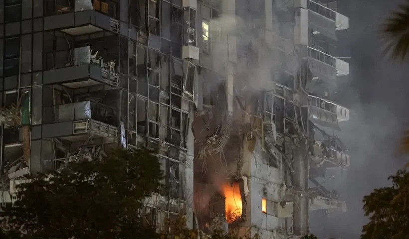 TOPSHOT - Fire and smoke rise from a building, reportedly hit by a missile fired from Iran, in central Tel Aviv on June 13, 2025. Iran fired a barrage of ballistic missiles at Israel in a counter-strike in the evening on June 13, after an unprecedented onslaught hammered the Islamic republic's top military brass and targeted its nuclear facilities and bases. (Photo by Jack GUEZ / AFP) (Photo by JACK GUEZ/AFP via Getty Images)