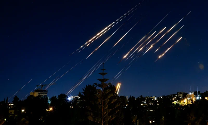 TOPSHOT - Missiles fired from Iran are pictured in the night sky over Jerusalem on June 14, 2025. Israel and Iran exchanged fire on June 14, a day after Israel unleashed an unprecedented aerial bombing campaign that Iran said hit its nuclear facilities, "martyred" top commanders and killed dozens of civilians (Photo by Menahem Kahana / AFP) (Photo by MENAHEM KAHANA/AFP via Getty Images)