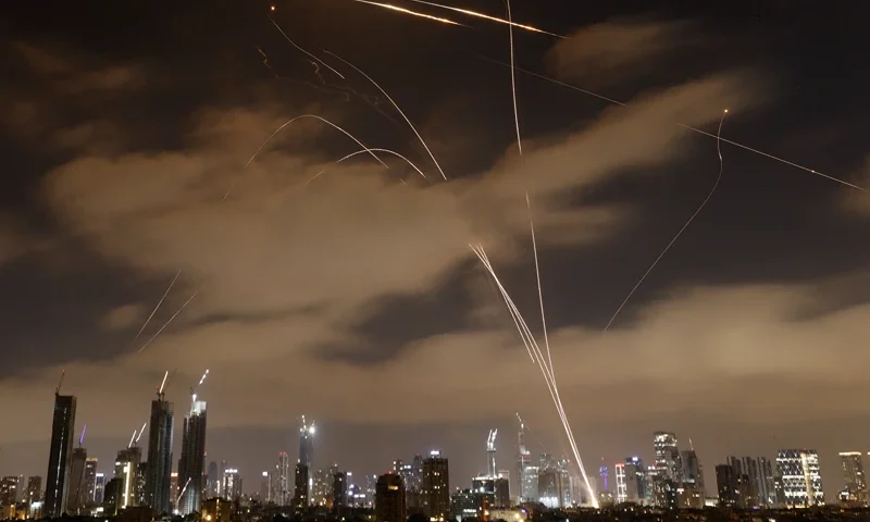 Israeli air defence systems intercept Iranian missiles over the Israeli city of Tel Aviv early on June 15, 2025. Air raid sirens and booms rang out in Jerusalem and Tel Aviv early on June 15, AFP journalists said, as Israel and Iran exchanged fire for a third day. (Photo by Jalaa MAREY / AFP) (Photo by JALAA MAREY/AFP via Getty Images)