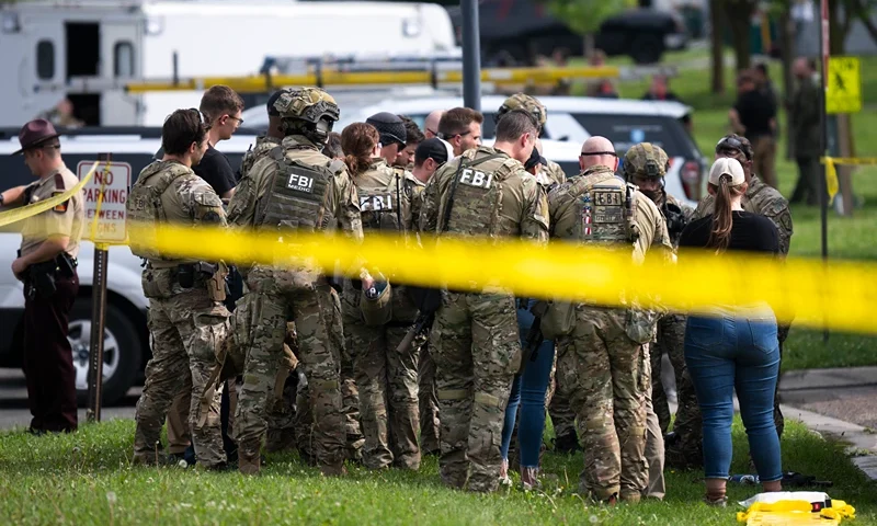 GREEN ISLE, MINNESOTA - JUNE 15: FBI agents stage in a neighborhood on June 15, 2025 in Green Isle, Minnesota. Law enforcement agencies are searching for Vance Boelter, a suspect in the killing of DFL State Rep. Melissa Hortman and her husband, Mark Hortman, who were shot at their home yesterday. DFL State Sen. John Hoffman and his wife were also shot and hospitalized in a separate incident. Minnesota Gov. Tim Walz said during a press conference that the shooting "appears to be a politically motivated assassination." (Photo by Stephen Maturen/Getty Images)
