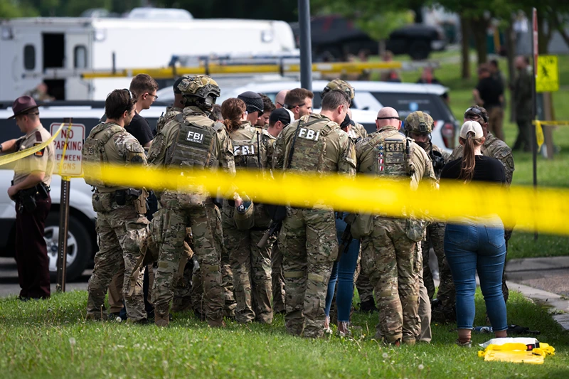 GREEN ISLE, MINNESOTA - JUNE 15: FBI agents stage in a neighborhood on June 15, 2025 in Green Isle, Minnesota. Law enforcement agencies are searching for Vance Boelter, a suspect in the killing of DFL State Rep. Melissa Hortman and her husband, Mark Hortman, who were shot at their home yesterday. DFL State Sen. John Hoffman and his wife were also shot and hospitalized in a separate incident. Minnesota Gov. Tim Walz said during a press conference that the shooting "appears to be a politically motivated assassination." (Photo by Stephen Maturen/Getty Images)