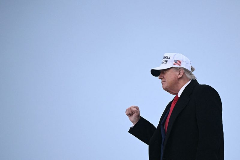 US President Donald Trump raises a fist as he steps off of Air Force One upon arrival at Calgary International Airport, before the start of the G7 summit, in Calgary, Alberta, Canada, June 15, 2025. (Photo by Brendan SMIALOWSKI / AFP) (Photo by BRENDAN SMIALOWSKI/AFP via Getty Images)