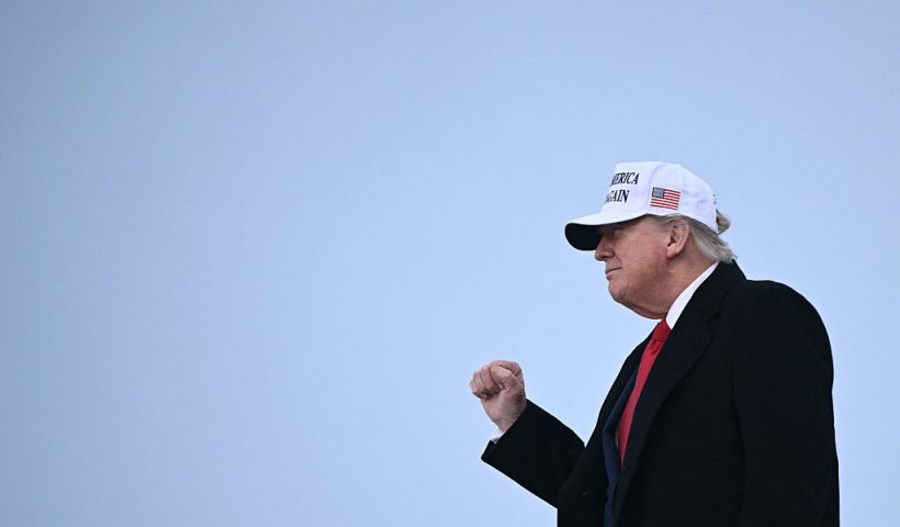 US President Donald Trump raises a fist as he steps off of Air Force One upon arrival at Calgary International Airport, before the start of the G7 summit, in Calgary, Alberta, Canada, June 15, 2025. (Photo by Brendan SMIALOWSKI / AFP) (Photo by BRENDAN SMIALOWSKI/AFP via Getty Images)