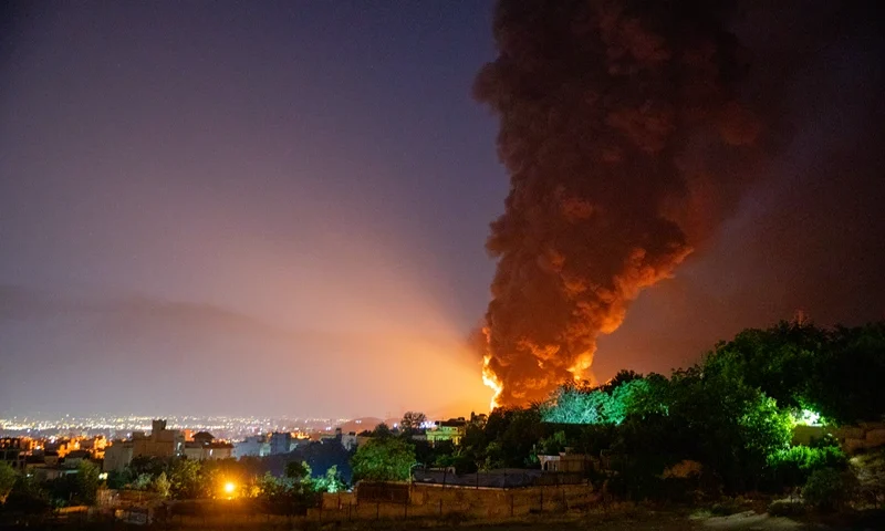TEHRAN, IRAN - JUNE 15: Fire and smoke rise into the sky after an Israeli attack on the Shahran oil depot on June 15, 2025 in Tehran, Iran. Iran's foreign minister said the country would respond decisively and proportionally to a wave of attacks that Israel launched beginning in the early hours of June 13. The attacks targeted multiple military, scientific and residential locations, as well as senior government officials. (Photo by Stringer/Getty Images)