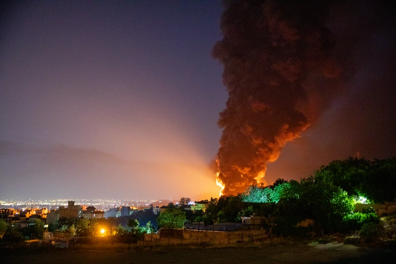 TEHRAN, IRAN - JUNE 15: Fire and smoke rise into the sky after an Israeli attack on the Shahran oil depot on June 15, 2025 in Tehran, Iran. Iran's foreign minister said the country would respond decisively and proportionally to a wave of attacks that Israel launched beginning in the early hours of June 13. The attacks targeted multiple military, scientific and residential locations, as well as senior government officials. (Photo by Stringer/Getty Images)