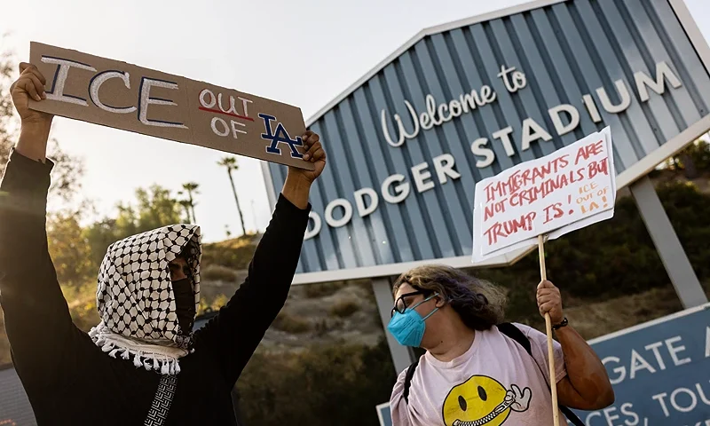 A small group of demonstrators protests outside the entrance of Dodger Stadium as the team plays tonight, claiming the organization supports federal immigration efforts, in Los Angeles, California, on June 19, 2025. Federal immigration agents were barred from entering Dodger Stadium on June 19 after requesting access to the Major League Baseball team's grounds, the team confirmed. US Immigration and Customs Enforcement (ICE) agents arrived at the stadium and "requested permission to access the parking lots," the Dodgers said in a statement. (Photo by ETIENNE LAURENT / AFP) (Photo by ETIENNE LAURENT/AFP via Getty Images)
