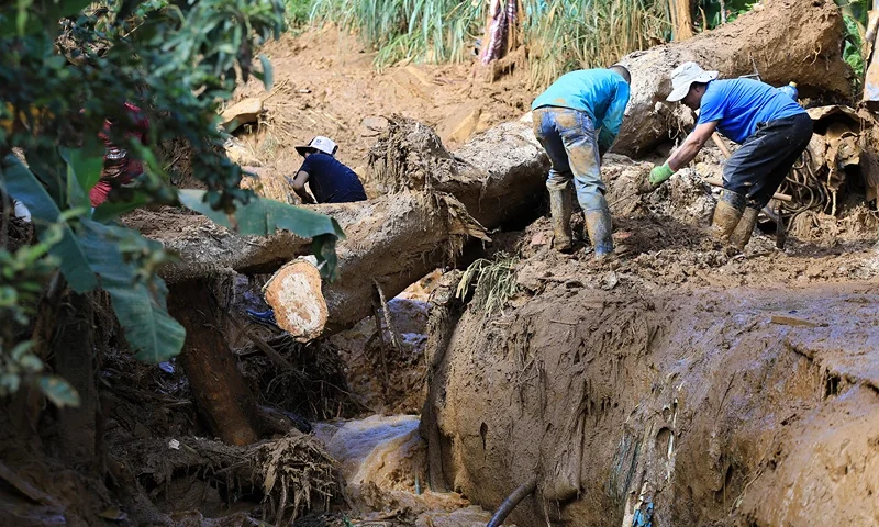 Men work to clear the area after a landslide in Bello, Antioquia Department, Colombia, on June 25, 2025. A landslide triggered by heavy rains killed at least 10 people and injured eight others on June 24 near the Colombian city of Medellin, government officials said. Locals were warned to evacuate the area in the municipality of Bello, which remained vulnerable to landslides, the governor of the Antioquia Department, Andres Julian Rendon, said while confirming the casualties. (Photo by JAIME SALDARRIAGA / AFP) (Photo by JAIME SALDARRIAGA/AFP via Getty Images)