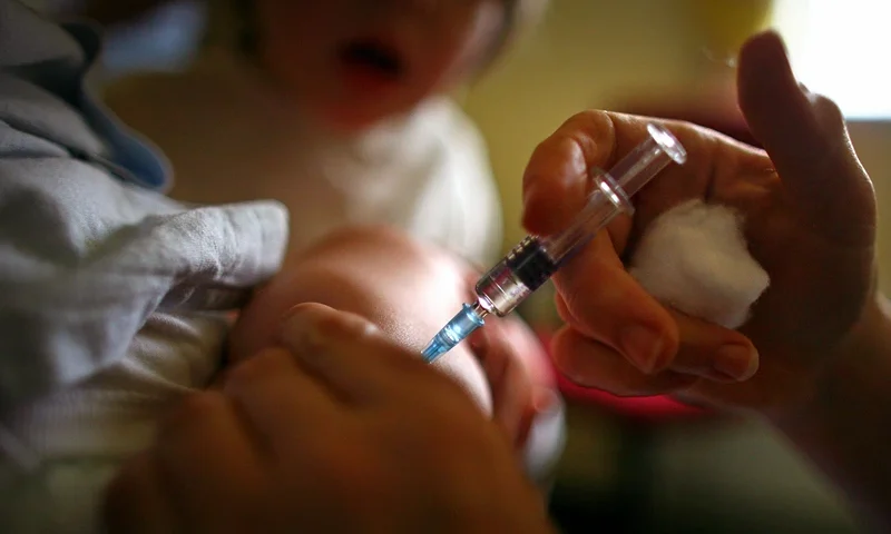 GLASGOW, UNITED KINGDOM - SEPTEMBER 03: A young boy receives a immunization jab at a health centre in Glasgow September 3, 2007 in Glasgow, Scotland. Medical experts still believe the MMR jab is safe and that the vaccine does not cause autism. (Photo by Jeff J Mitchell/Getty Images)