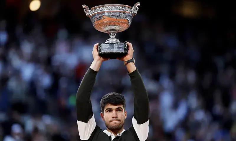 Spain's Carlos Alcaraz celebrates with the trophy after winning the men's singles final against Italy's Jannik Sinner REUTERS/Stephanie Lecocq