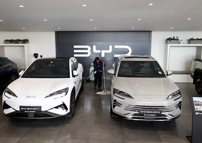 Amukelani Masungi, a worker, cleans the floor next to BYD vehicles on display at a BYD dealership in Sandton, South Africa, June 5, 2025. REUTERS/Siphiwe Sibeko/File Photo