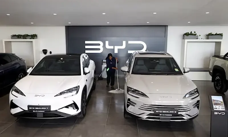 Amukelani Masungi, a worker, cleans the floor next to BYD vehicles on display at a BYD dealership in Sandton, South Africa, June 5, 2025. REUTERS/Siphiwe Sibeko/File Photo
