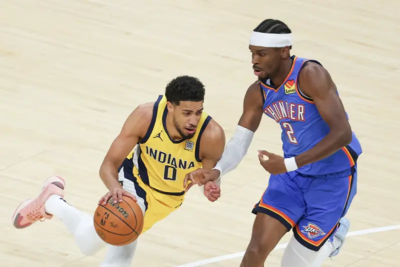 Indiana Pacers guard Tyrese Haliburton (0) drives to the basket against Oklahoma City Thunder guard Shai Gilgeous-Alexander (2) in the first quarter during game six of the 2025 NBA Finals at Gainbridge Fieldhouse. Mandatory Credit: Trevor Ruszkowski-Imagn Images