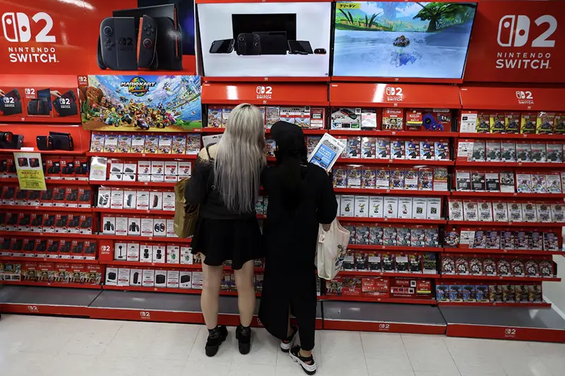 People shop at an electronics store as Nintendo starts selling the new consoles globally, in Tokyo, Japan June 5, 2025. REUTERS/Issei Kato
