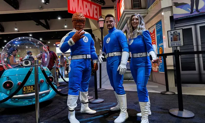 Booth attendees dressed as the Fantastic Four pose for a picture at the Marvel booth on the convention floor at Comic-Con International in San Diego, California, U.S. July 24, 2025. REUTERS/Mike Blake