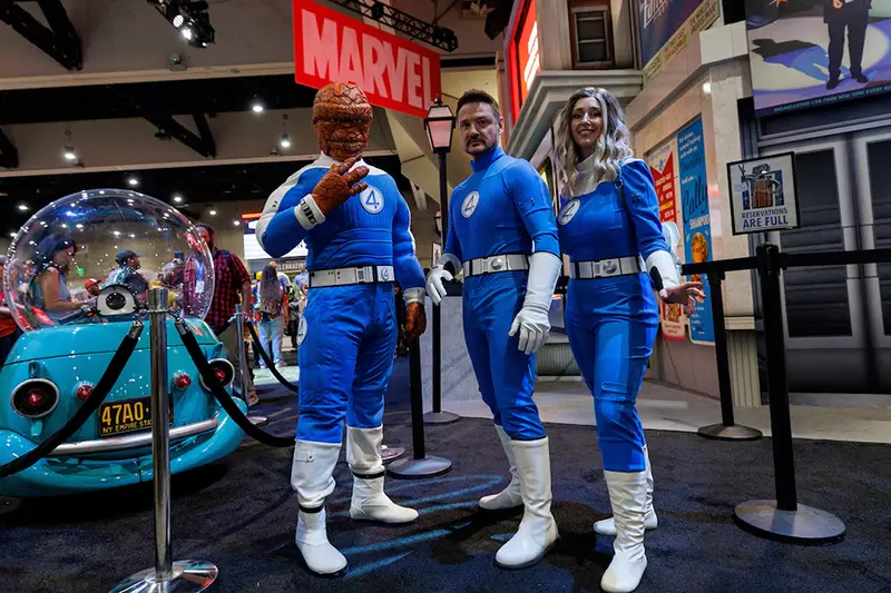 Booth attendees dressed as the Fantastic Four pose for a picture at the Marvel booth on the convention floor at Comic-Con International in San Diego, California, U.S. July 24, 2025. REUTERS/Mike Blake