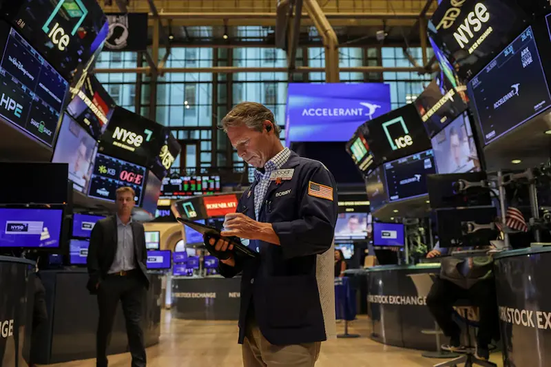A trader works on the floor at the New York Stock Exchange (NYSE) in New York City, U.S., July 25, 2025. REUTERS/Jeenah Moon/File photo