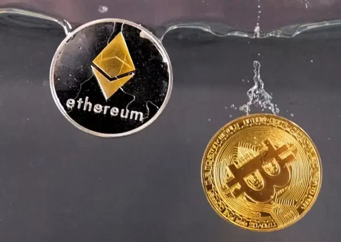 Souvenir tokens representing cryptocurrency Bitcoin and the Ethereum network, with its native token ether, plunge into water in this illustration taken May 17, 2022. REUTERS/Dado Ruvic/Illustration/File Photo