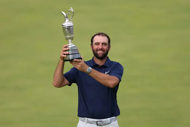 Scottie Scheffler of the U.S. celebrates with the Claret Jug trophy after winning The 153rd Open Championship REUTERS/Russell Cheyne