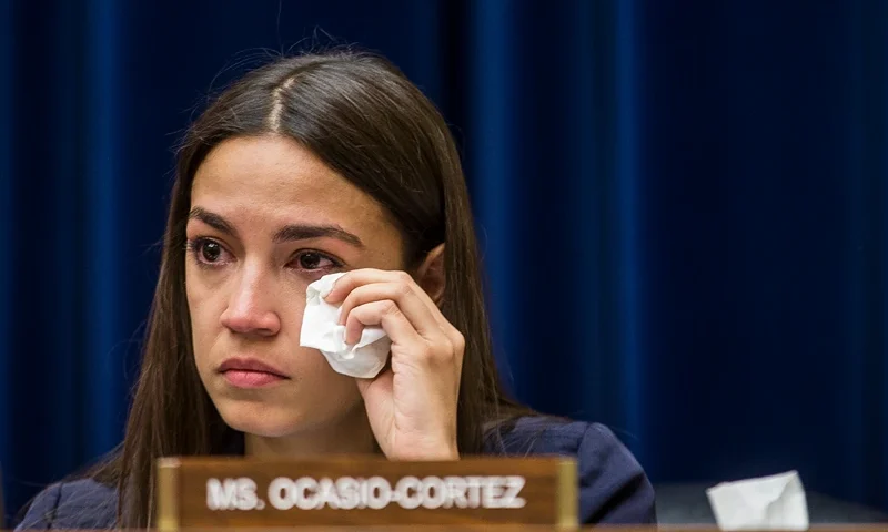 WASHINGTON, DC - JULY 10: Rep. Alexandria Ocasio-Cortez (D-NY) wipes a tear during a House Oversight and Reform subcommittee on Civil Rights and Civil Liberties hearing discussing migrant detention centers' treatment of children on Capitol Hill on July 10, 2019 in Washington, DC. Yazmin Juarez, whose 19-month-old daughter Mariee died after detention by ICE testified. (Photo by Zach Gibson/Getty Images)