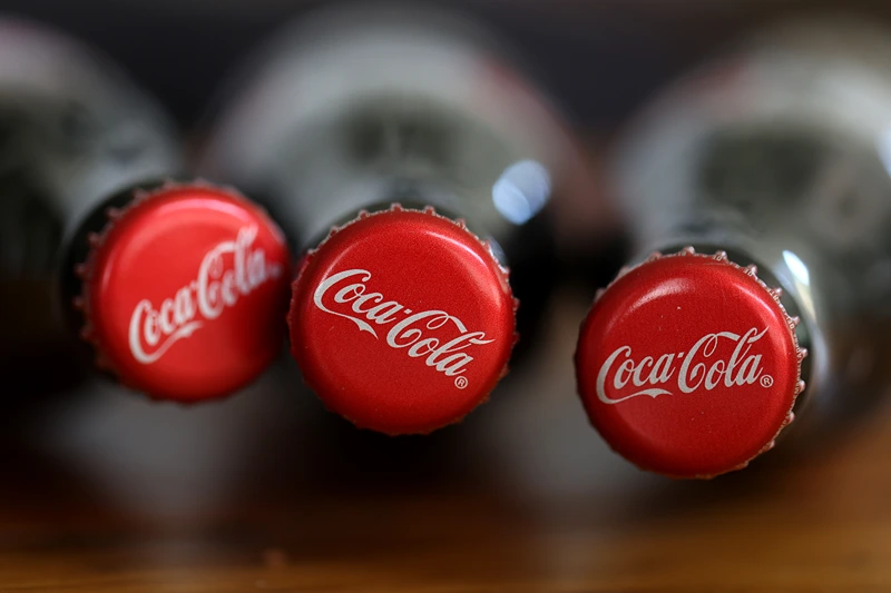 SAN ANSELMO, CALIFORNIA - APRIL 24: In this photo illustration, bottles of Coca Cola are displayed on April 24, 2023 in San Anselmo, California. Coca-Cola reported first-quarter earnings that beat analyst expectations with revenues of $10.96 billion compared to the expected $10.8 billion. (Photo Illustration by Justin Sullivan/Getty Images)
