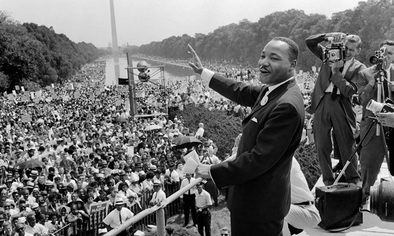 TOPSHOT - US civil rights leader Martin Luther King (C) waves to supporters 28 August 1963 on the Mall in Washington DC (Washington Monument in background) during the "March on Washington", where King delivered his famous "I Have a Dream" speech, which mobilized supporters of desegregation and prompted the Civil Rights Act of 1964. King said the march was "the greatest demonstration of freedom in the history of the United States." Martin Luther King was assassinated on 04 April 1968 in Memphis, Tennessee. James Earl Ray confessed to shooting King and was sentenced to 99 years in prison. King's killing sent shock waves through American society at the time, and is still regarded as a landmark event in recent US history. AFP PHOTO (Photo by AFP) (Photo by -/AFP via Getty Images)