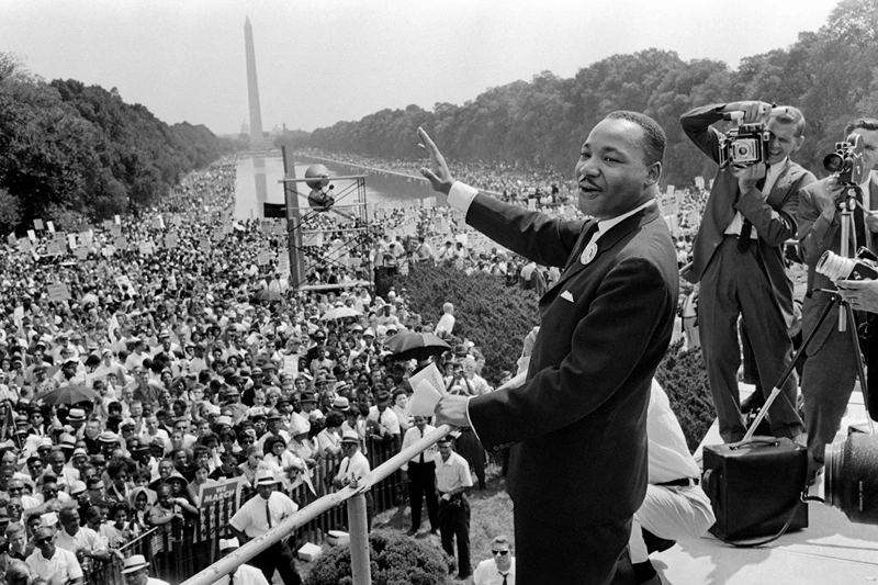 TOPSHOT - US civil rights leader Martin Luther King (C) waves to supporters 28 August 1963 on the Mall in Washington DC (Washington Monument in background) during the "March on Washington", where King delivered his famous "I Have a Dream" speech, which mobilized supporters of desegregation and prompted the Civil Rights Act of 1964. King said the march was "the greatest demonstration of freedom in the history of the United States." Martin Luther King was assassinated on 04 April 1968 in Memphis, Tennessee. James Earl Ray confessed to shooting King and was sentenced to 99 years in prison. King's killing sent shock waves through American society at the time, and is still regarded as a landmark event in recent US history. AFP PHOTO (Photo by AFP) (Photo by -/AFP via Getty Images)