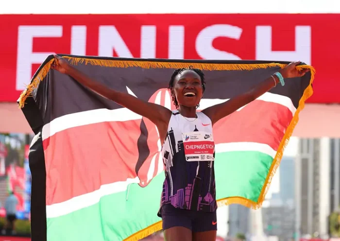 Ruth Chepngetich of Kenya celebrates after crossing the finish line to win the 2024 Chicago Marathon professional women's division and setting a new world record with a time of 2:09:56 at Grant Park on October 13, 2024 in Chicago, Illinois. (Photo by Michael Reaves/Getty Images)