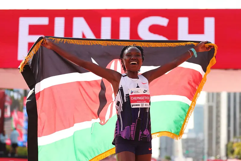 Ruth Chepngetich of Kenya celebrates after crossing the finish line to win the 2024 Chicago Marathon professional women's division and setting a new world record with a time of 2:09:56 at Grant Park on October 13, 2024 in Chicago, Illinois. (Photo by Michael Reaves/Getty Images)